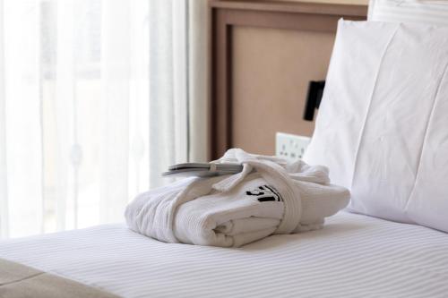 a pile of towels sitting on top of a bed at M31Boutique Suites in Mellieħa