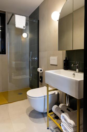 a bathroom with a sink and a toilet and a shower at M31Boutique Suites in Mellieħa