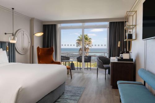 a hotel room with a bed and a view of the ocean at Radisson Collection Hotel, Waterfront Cape Town in Cape Town