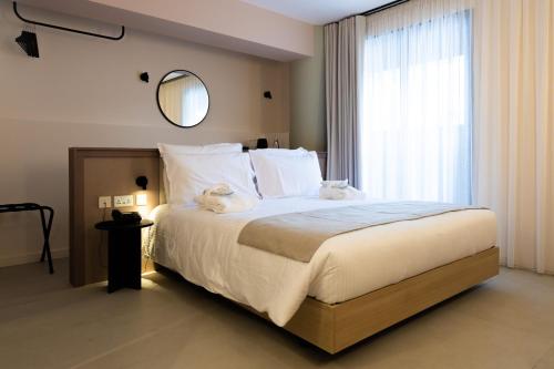 a bedroom with a large bed with a large window at M31Boutique Suites in Mellieħa