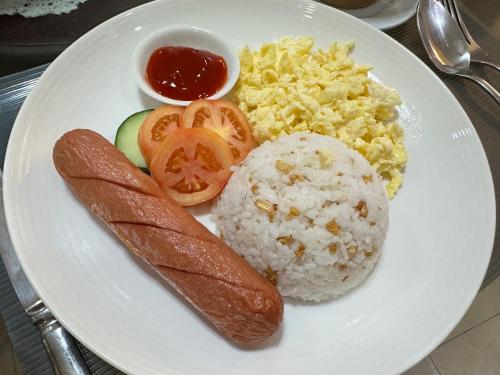 a white plate of food with rice and vegetables at Lee Boutique Hotel Tagaytay in Tagaytay