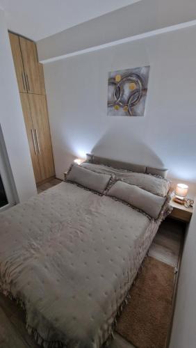 a bedroom with a bed with a painting on the wall at cocoluxapartmanl73 in Trnava