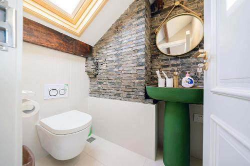 a bathroom with a white toilet and a mirror at Tonight Homestay West Nanjing Road Shanghai in Shanghai