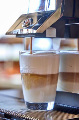 a drink is being poured into a glass at Hotel Drei Mohren in Garmisch-Partenkirchen