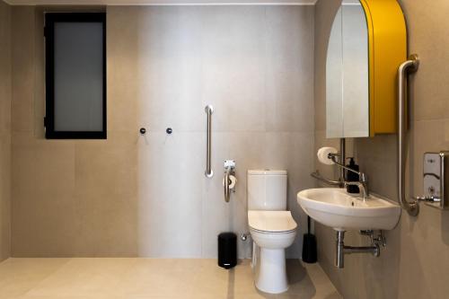 a bathroom with a toilet and a sink at M31Boutique Suites in Mellieħa