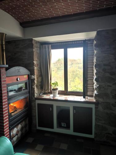 a kitchen with a window and a stove at Al Cantello in Galati Mamertino