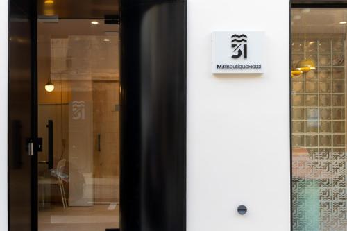 a door of a store with a sign on it at M31Boutique Suites in Mellieħa