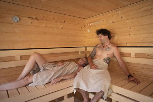 a man and a woman in a sauna at Apartment Schichlreit in Annaberg im Lammertal