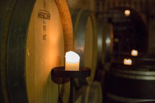 a candle on a table next to a wine barrel at Romantik Hotel Zur Schwane in Volkach