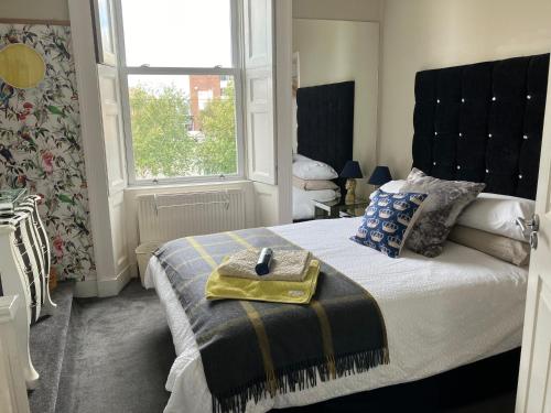a bedroom with a bed with a purse on it at Apartment 28 in Ayr