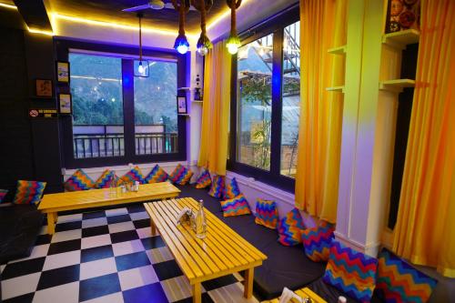 a restaurant with colorful chairs and a table in a room at Friends by Alizeh Bhagsunag McLeodganj in McLeod Ganj