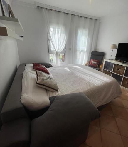 a bedroom with a large bed and a couch at The Snow Chalet con Parking, Wifi y Terraza in Sierra Nevada