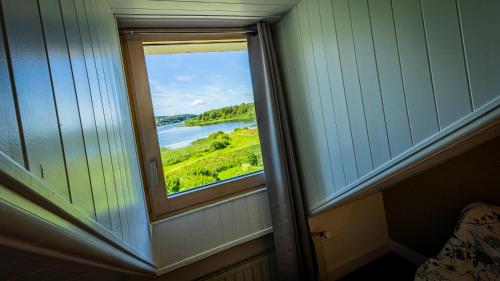 a window in a room with a view of a river at Hotel Lou Granva in Grande Riviere