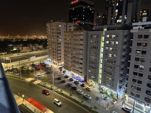 an aerial view of a city at night at Amazing Sea View Stay Abu Dhabi in Abu Dhabi