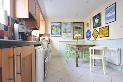 a kitchen with a table and a dining room at Central Dingle Townhouse in Dingle