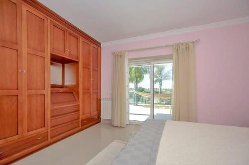 a bedroom with a bed and a large window at Quinta do Sol in Guia