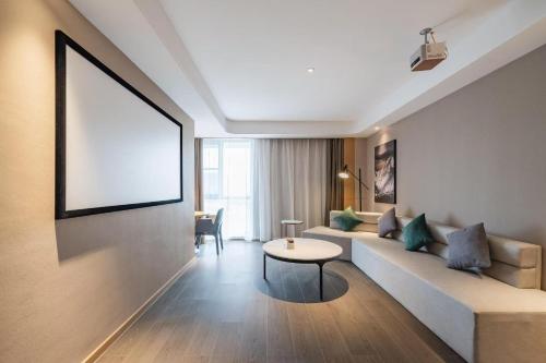 a living room with a couch and a table at Atour Hotel Cixi Cultural Business District in Cixi