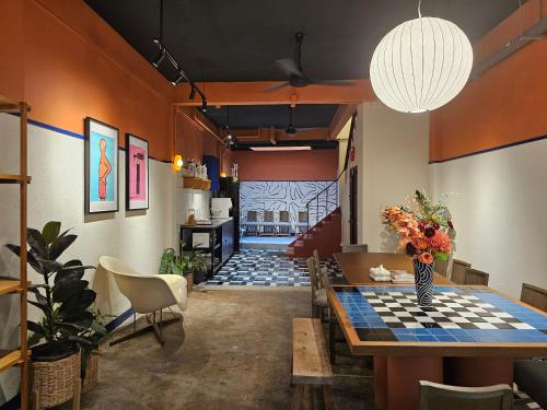a dining room with a table and a checkerboard table at Blu Dock Restel Bangkok in Bangkok