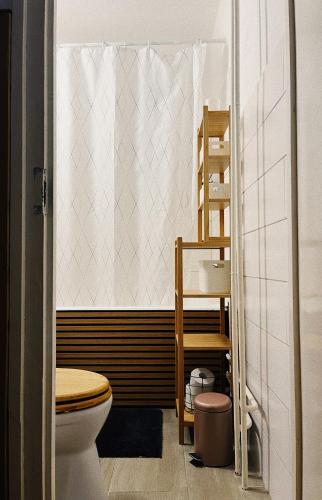 a bathroom with a toilet and a sink at AJ - tér apartman miskolc in Miskolc