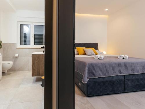 a bedroom with a bed and a bathroom at Holiday Home Lozo by Interhome in Gornji Proložac