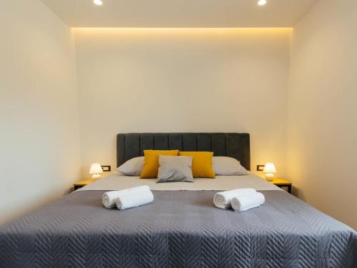 a bedroom with a large bed with two towels on it at Holiday Home Lozo by Interhome in Gornji Proložac