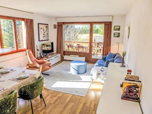 a living room with a table and chairs at Apartment La Verdure Est N-22 by Interhome in Crans-Montana
