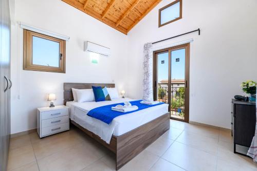 a bedroom with a bed and a balcony at Kymma Villa #12 in Ayia Napa