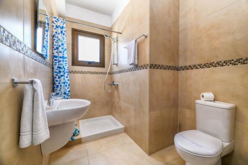 a bathroom with a toilet and a sink at Kymma Villa #12 in Ayia Napa