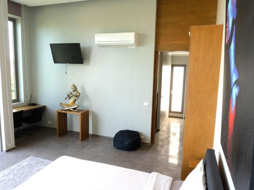 a bedroom with a statue of a person sitting on a table at Phuket 4-Bedrooms Seaview 884m2 Private XL Luxury Infinity Pool Villa in Ban Pa Khlok