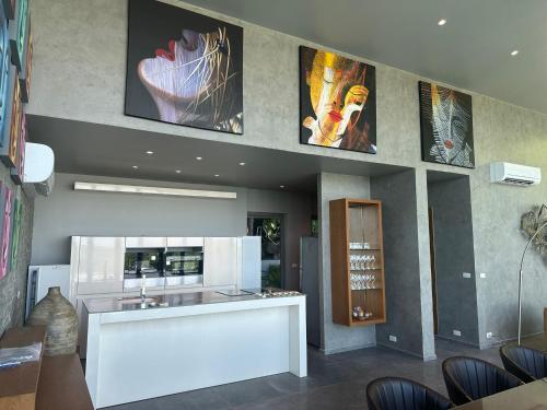 a kitchen with a sink and some pictures on the wall at Phuket 4-Bedrooms Seaview 884m2 Private XL Luxury Infinity Pool Villa in Ban Pa Khlok