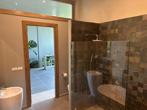 a bathroom with two sinks and a glass shower at Phuket 4-Bedrooms Seaview 884m2 Private XL Luxury Infinity Pool Villa in Ban Pa Khlok