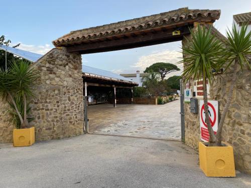an entrance to a building with a stone wall at Villas Dehesa Roche Viejo in Conil de la Frontera