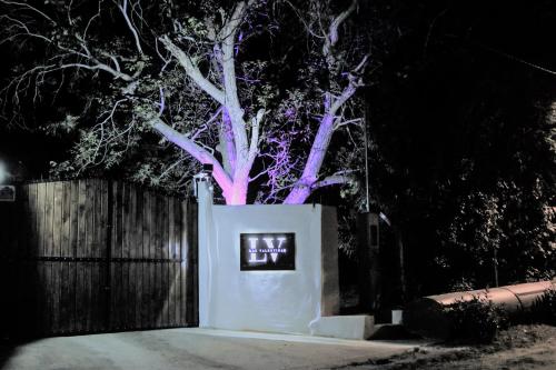 a tree with purple lights in front of a fence at Las Valentinas Hospedaje de Montaña in Chilecito