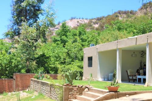 a small house with a hill in the background at Las Valentinas Hospedaje de Montaña in Chilecito