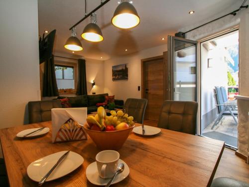 a dining room table with a bowl of fruit on it at Apartment Stöckl by Interhome in Schwendau