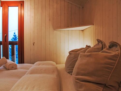 a room with three beds and a window at Chalet Chalet Grepon by Interhome in Saclentse