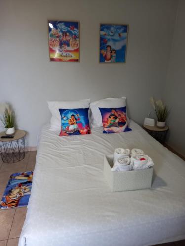 - un lit blanc avec une boîte de serviettes dans l'établissement C101 Appartement DisneyLand Montevrain, à Montévrain