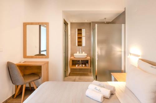 a bathroom with a bed and a sink at Sunset Villa in Paralia Dionysiou