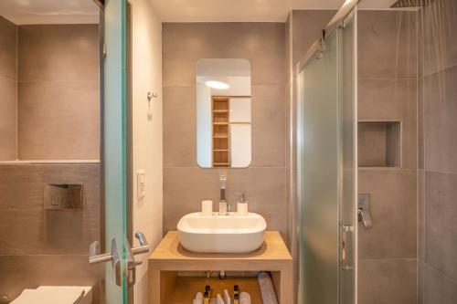 a bathroom with a sink and a shower at Sunset Villa in Paralia Dionysiou