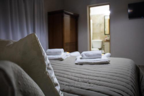 a bedroom with a bed with towels on it at Las Valentinas Hospedaje de Montaña in Chilecito