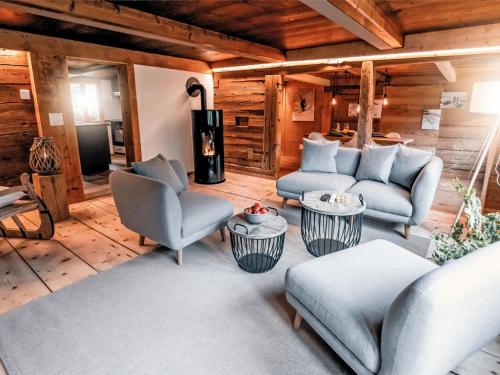 a living room with two chairs and a couch at Apartment Chalet Solegg by Interhome in Innertkirchen