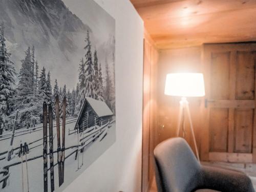 a room with a chair and a picture on the wall at Apartment Chalet Solegg by Interhome in Innertkirchen