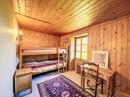 a bedroom with two bunk beds in a cabin at Chalet Sergnoud by Interhome in Lens