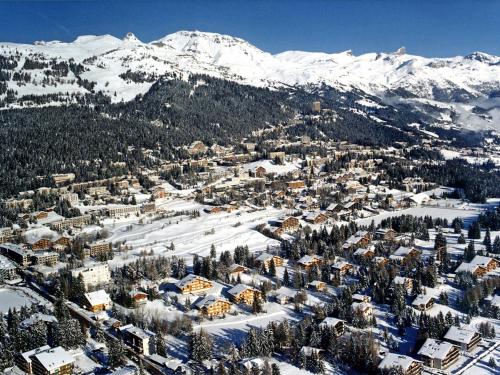 an aerial view of a town with snow covered mountains at Chalet Sergnoud by Interhome in Lens