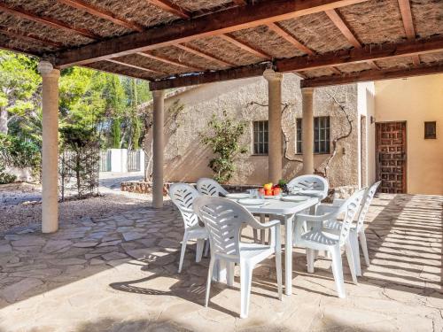 a white table and chairs on a patio at Villa Africa by Interhome in L'Ametlla de Mar
