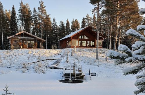a log cabin in the snow in front at Villa Kanger in Kuusamo