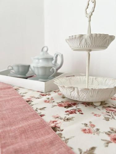 a table with two bowls and a tea kettle on it at Nina Home in Vico Equense