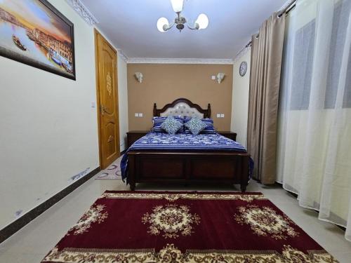 a bedroom with a bed and a rug on the floor at Blue Rawal in Bain Boeuf