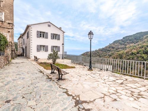 a bench and a street light next to a building at Holiday Home Casa Santa Reparata by Interhome in Santa-Reparata-di-Moriani