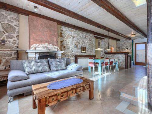 a living room with a couch and a table at Holiday Home Vista 2 by Interhome in Vrsar